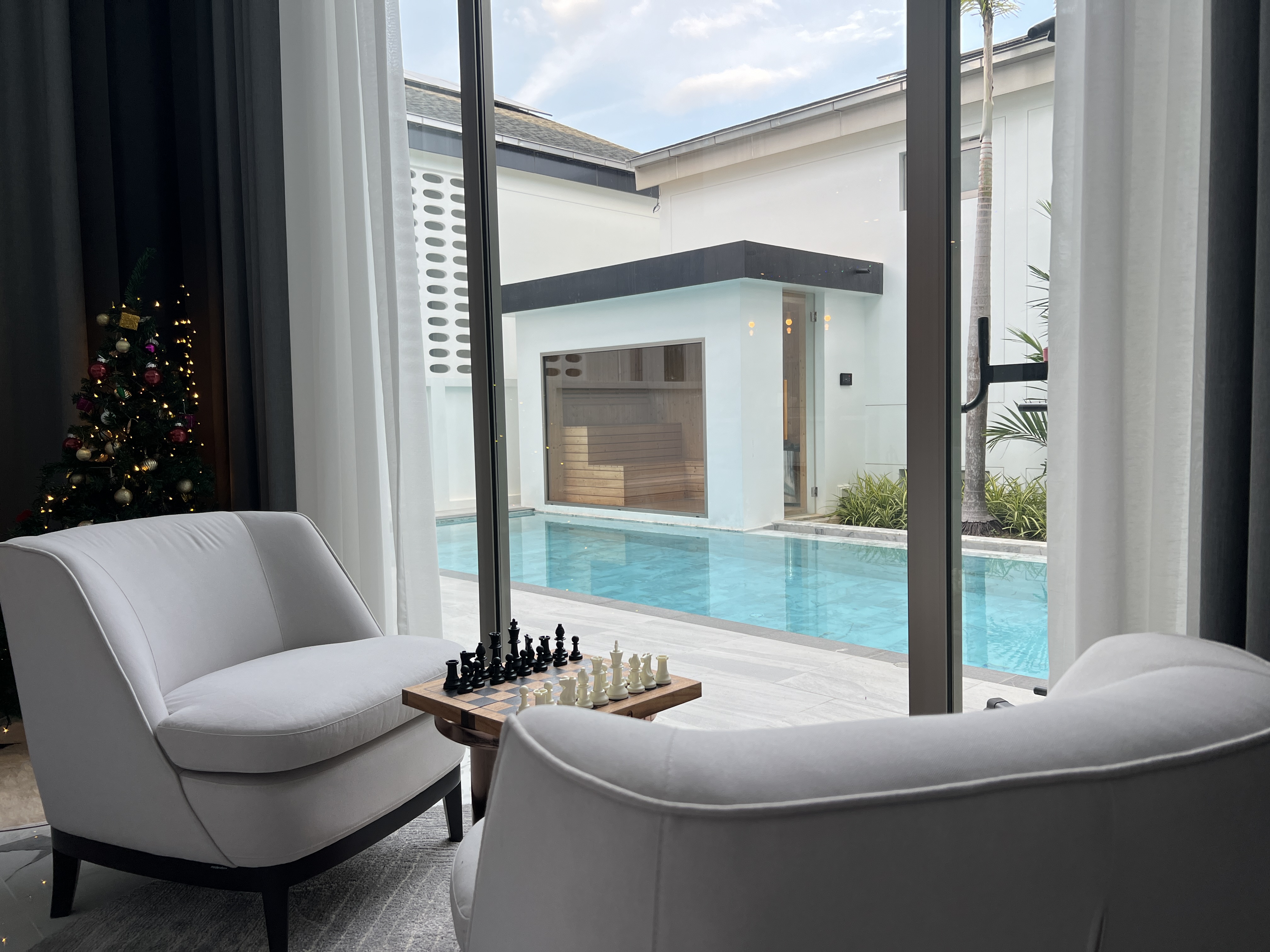 Elegant seating area with chess set overlooking pool and sauna
